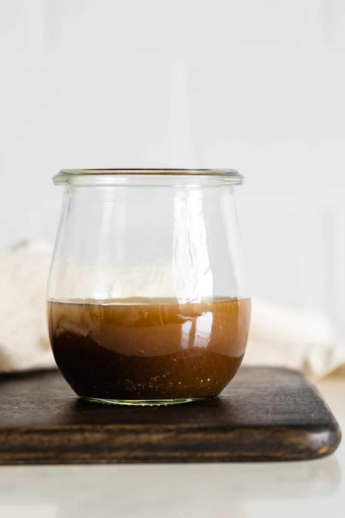 Maple Mustard Balsamic Dressing in a glass jar.