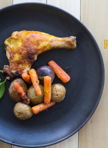 One Pan Honey Mustard Chicken on a black plate on a wooden table with text overlay.