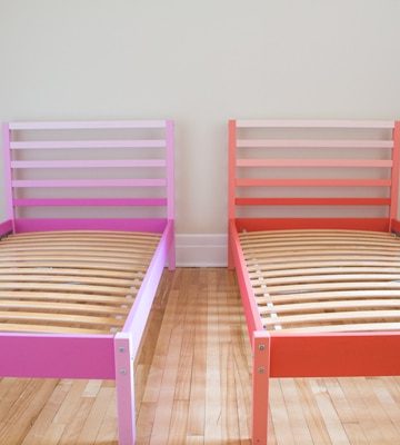 Pink and orange Ikea Tarva Beds side by side in a bedroom.