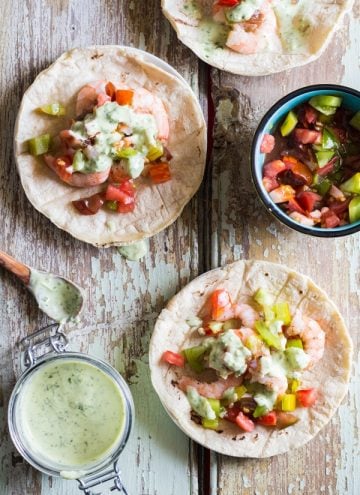 Shrimp Tacos with Cilantro Lime Salsa, a cup of salsa and a cup of chopped tomatoes.
