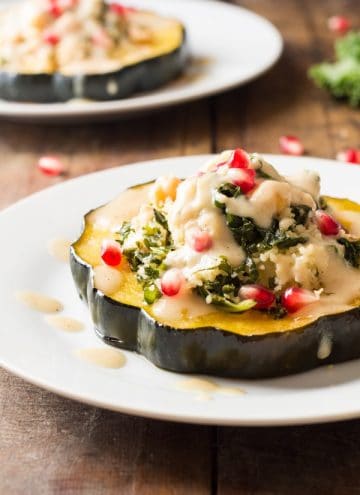 Two plates of Bulgur Stuffed Acorn Squash.