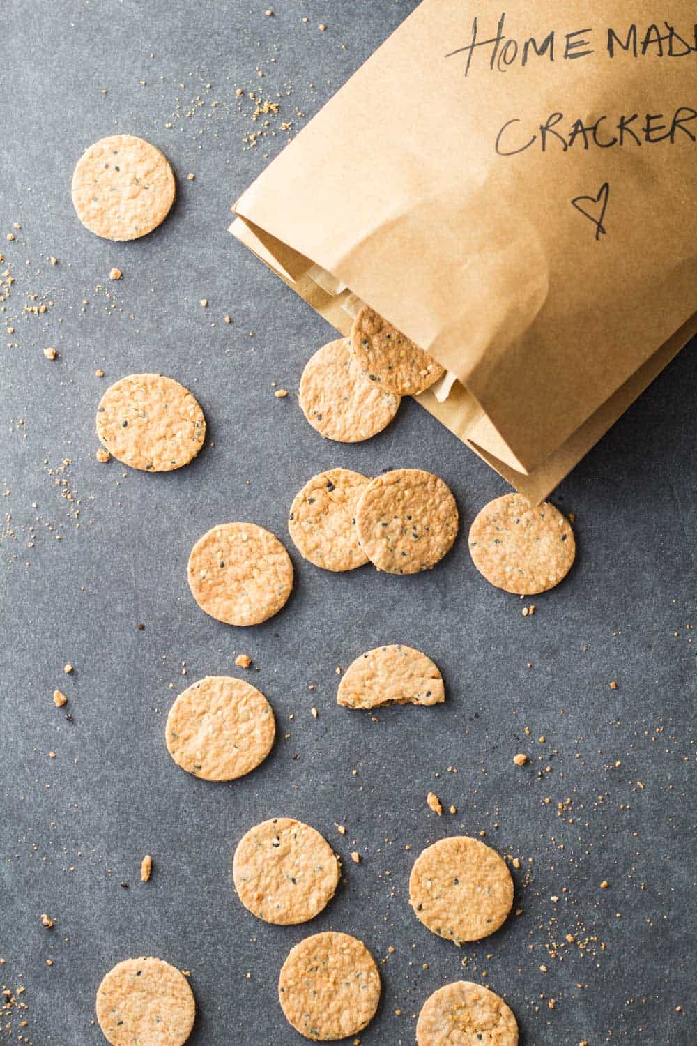 Top view of Homemade Crackers scattered on the counter from a paper bag.