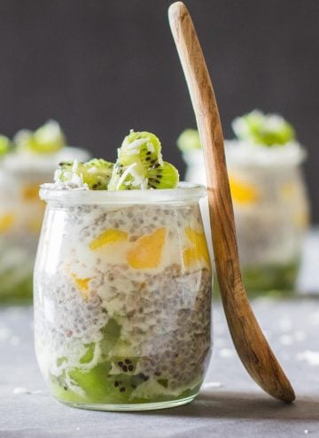 Close up of jar of Tropical Chia Pudding with a wooden spoon.
