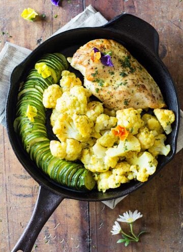 One-Pan Curried Chicken Cauliflower with sliced zucchini in a skillet.