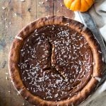 Top view of Healthy Pumpkin Pie with little pumpkins on the side.