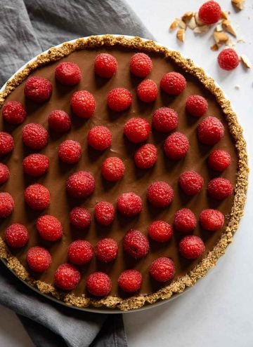 Chocolate Raspberry Tart with grey napkin next to it.