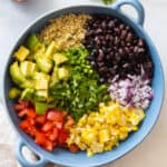 Mexican Quinoa Salad ingredients shown separately in a blue bowl before mixing.