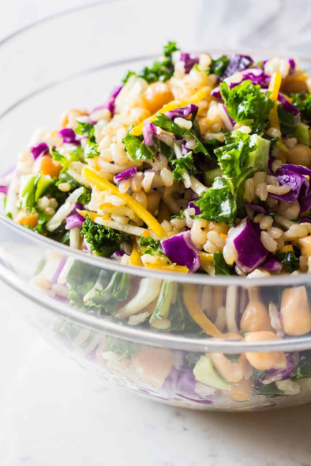 Close-up image of brown rice salad with julienned beets and kale