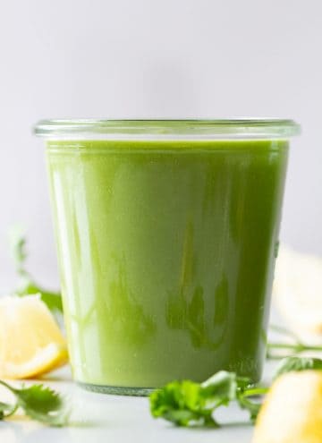 A vibrantly green Keto Smoothie in a glass.
