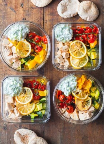 4 Greek Chicken Meal Prep Bowls with Tzatziki and pita bread