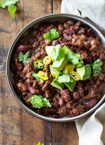 Instant Pot Vegan Chili topped with fresh avocado, cilantro and chili slices