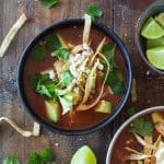 Crock Pot Chicken Tortilla Soup topped with crispy tortilla strips, avocado, cilantro and queso fresco