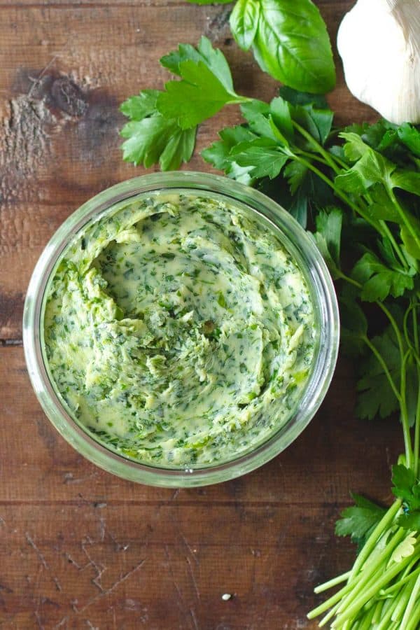 Garlic herb butter is a delicious compound butter made with fresh herbs and roasted garlic. This homemade condiment recipe makes the perfect topping for baked or mashed potatoes, garlic bread, or pasta. Herb Garlic Butter in a jar
