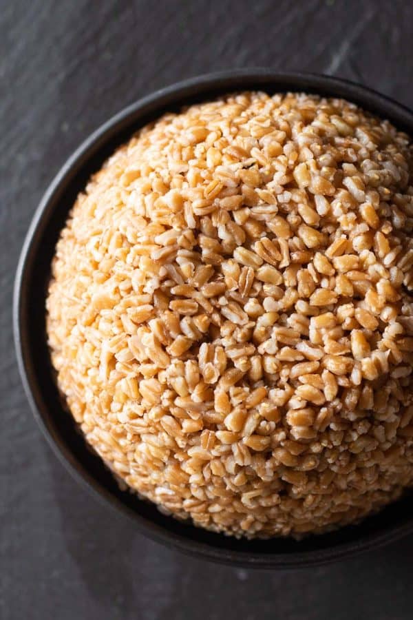 cooked farro in a black bowl