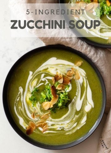 Zucchini Soup in Bowl topped with crème fraîche and sliced almonds