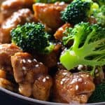 Closeup shot of chicken and broccoli in a soy-sauce stir-fry sauce