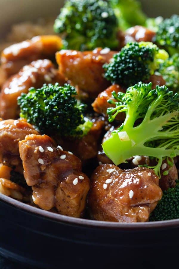 Closeup shot of chicken and broccoli in a soy-sauce stir-fry sauce