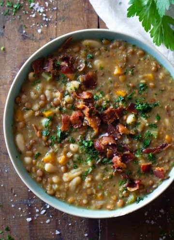 Crockpot Lentil Soup in a blue bowl topped with bacon