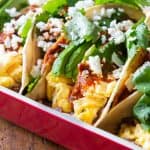 Closeup of Breakfast Tacos with scrampled eggs and avocado and salsa and cilantro as toppings