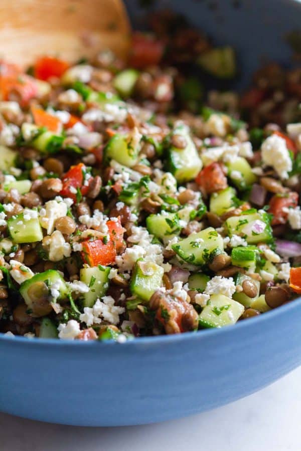 mixed up lentil salad in a blue bowl
