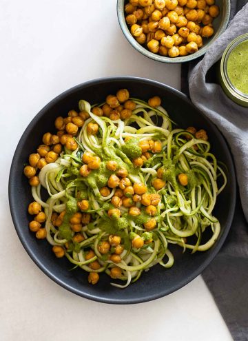 Zucchini noodles topped with crispy chickpeas and herb sauce.