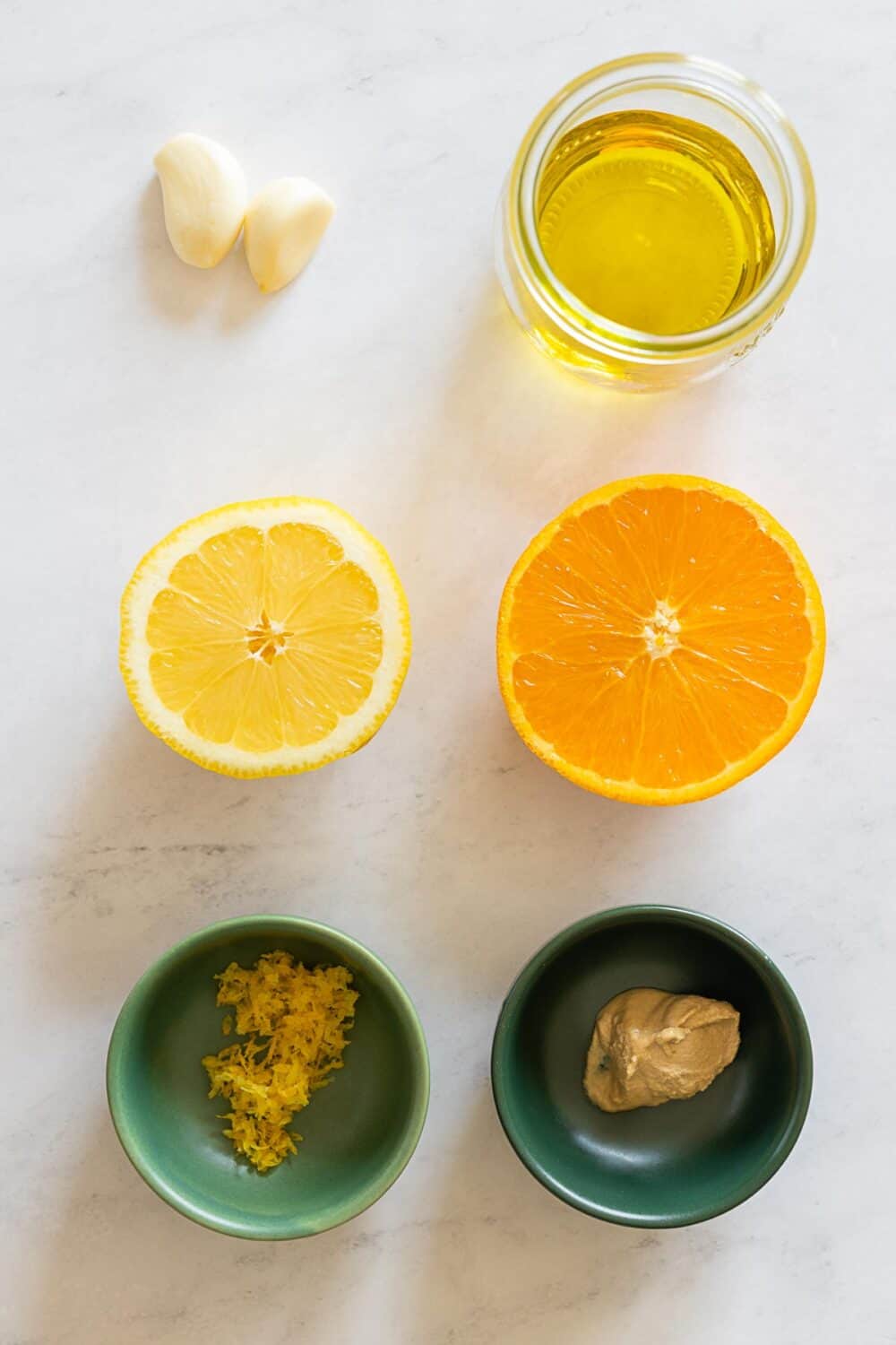 Ingredients for citrus dressing laid out on a kitchen counter.