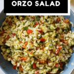 Lemon Orzo Salad in a blue bowl shown from the top down with text overlay for Pinterest.