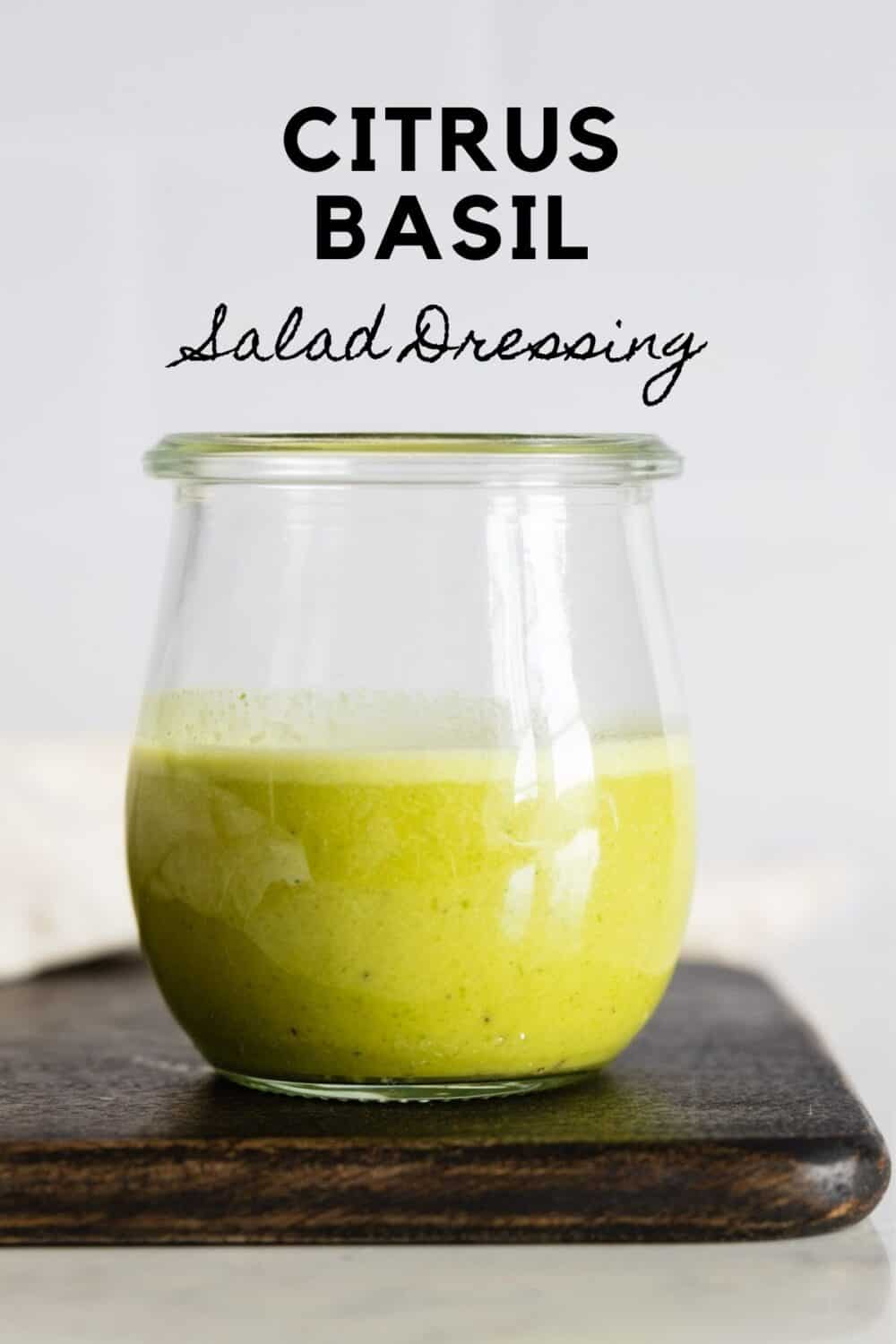 Glass jar with green salad dressing with title reading: Citrus Basil Salad Dressing.