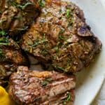 Grilled lamb chops on a plate.