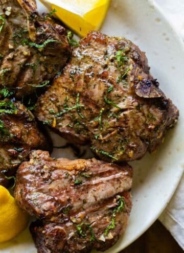 Grilled lamb chops on a plate.