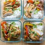 Four meal prep bowls filled with chicken fajitas and rice.