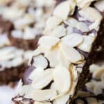 Close-up shot of one granola bar with sliced almonds on top.