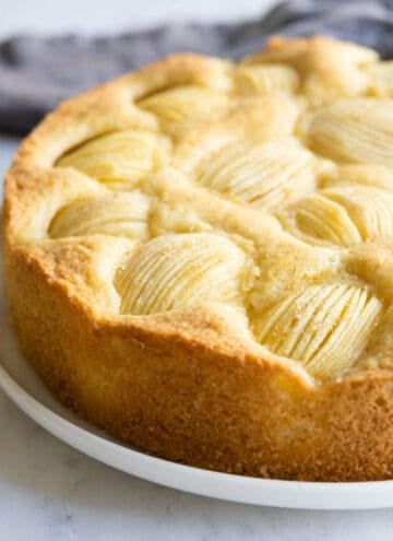 German Apple Cake, also known as Versunkener Apfelkuchen, on a white plate.
