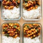 Four chipotle chickepe meal prep bowls next to each other showing white rice and chickpea stew.