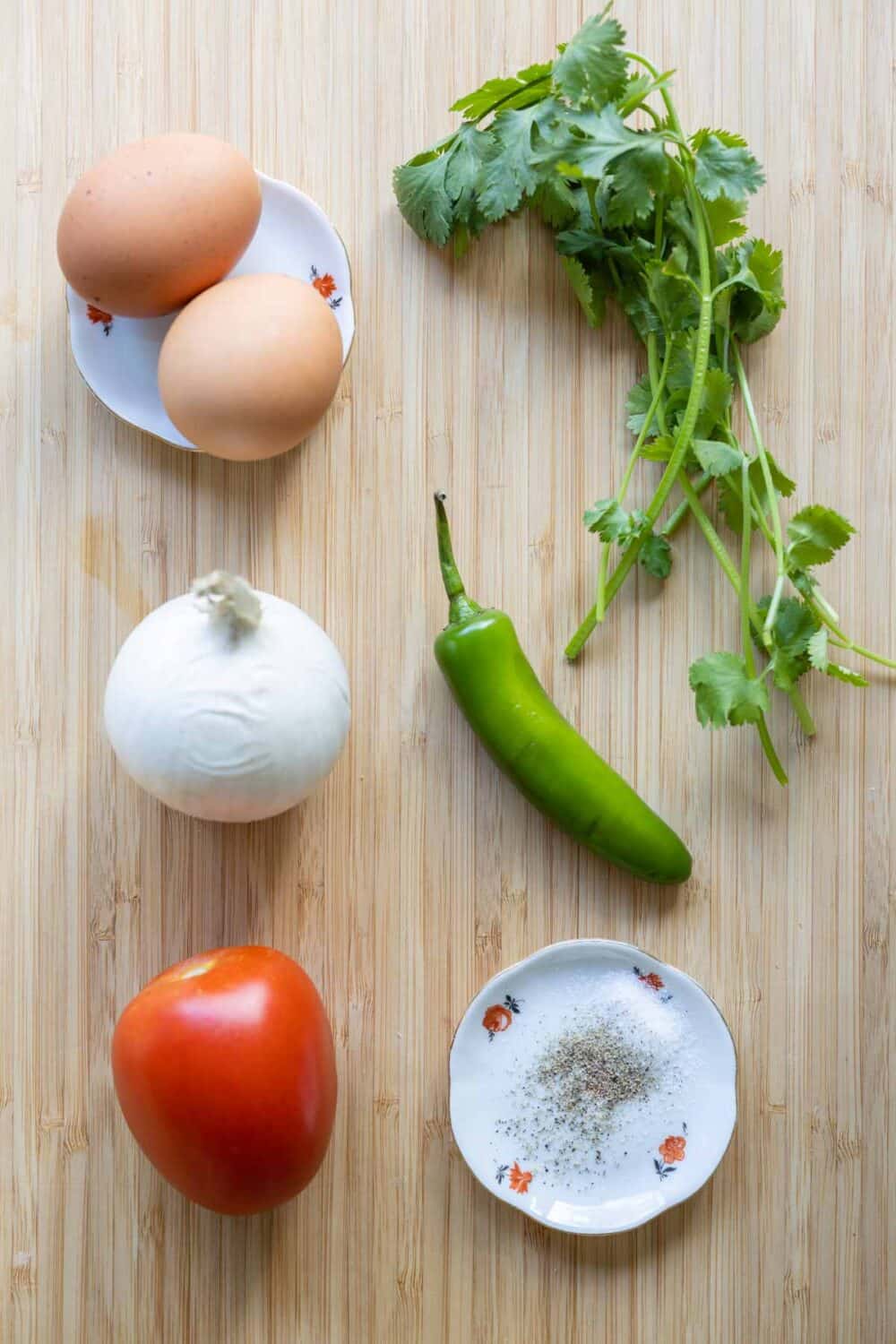 Ingredients for Mexican scrambled eggs laid out on a kitchen counter.