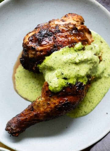 Pollo a a la brasa with ají verde sauce on top.