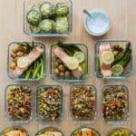 15 Healthy Meals in meal prep containers laid out on a kitchen counter.