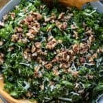 Kale Crunch Salad in a grey salad bowl with wooden spoons.