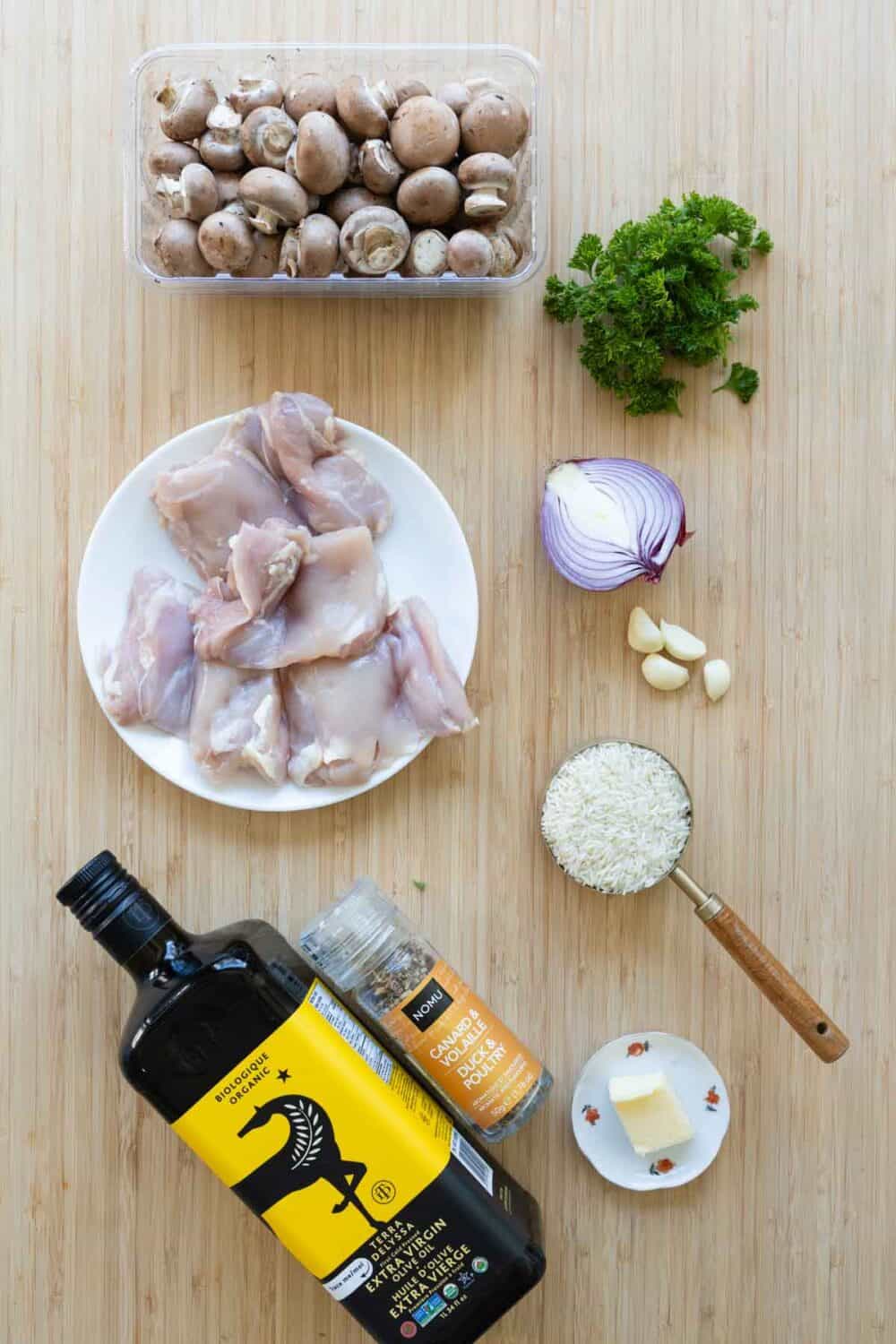 Ingredients for Mushroom Rice with Chicken Thighs laid out on a kitchen counter. 